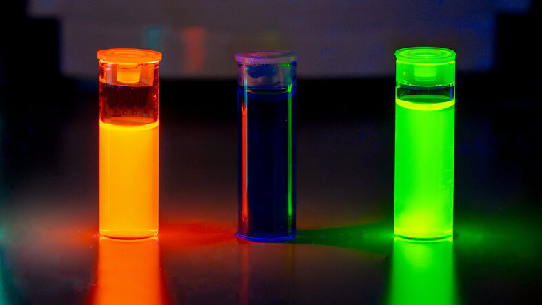 Test tubes containing fluorescent liquids in different colours